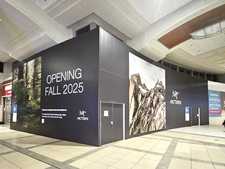 Arc'teryx storefront hoarding graphics with mountain imagery in a mall
